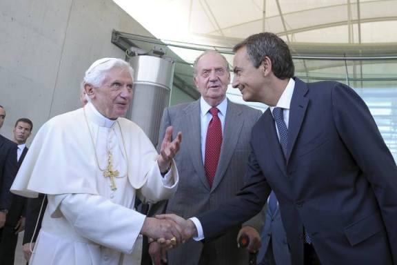 Pope Benedict XVI shakes hands with Spain's PM Zapatero next to Spain's King Juan Carlos after arriving at Madrid's Barajas airport from Rome