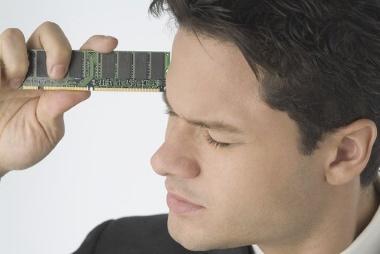 Young man holding computer RAM against his head