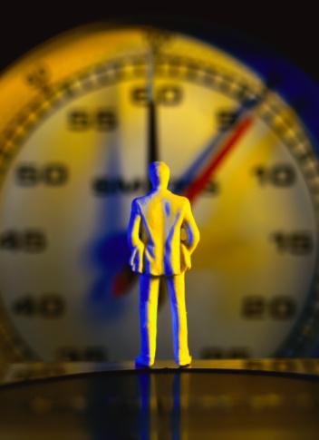 view from behind of a male figure facing a stopwatch