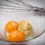 Yemas de huevo, mostaza, sal y pimienta, en un cuenco.