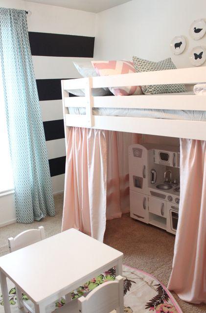 precious little girls room with a loft bed, pink curtains, black and white striped walls, play kitchen