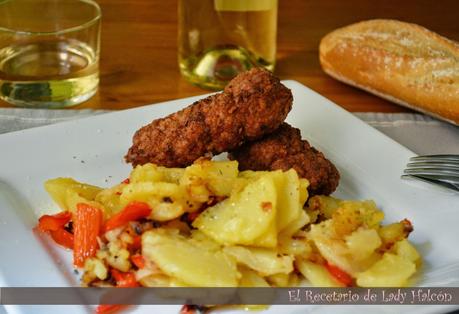Rollitos de carne especiados acompañados de patatas y pimiento rojo
