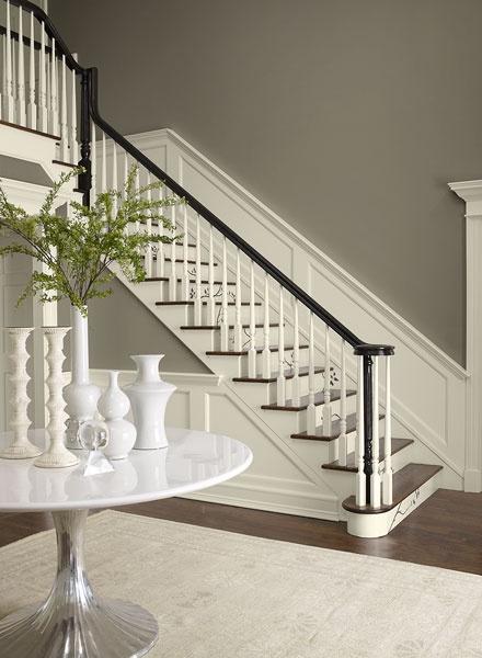 Hallway in contrasting neutral paint colors - Benjamin moore - taos taupe 2111-40 walls, collector's item AF-45 stair risers, trim and wainscotting, hasbrouck brown HC-71 accent