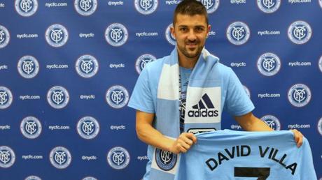 15 David Villa on the NYCFC backdrop holding named shirt4