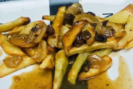 chuletas de cerdo con verduras y salsa de pasas y cava acompañadas de patatas fritas