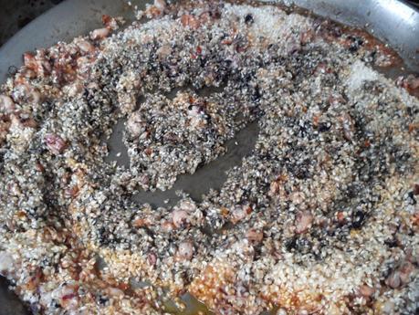 Arroz negro en paella (traditional black rice paella,  mediterranean style)