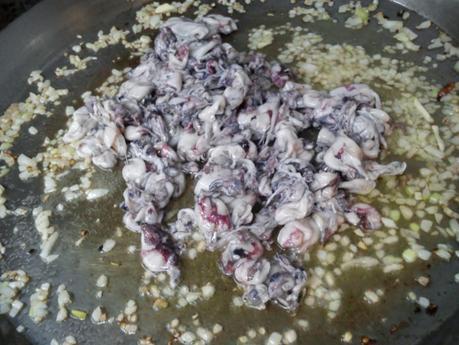 Arroz negro en paella (traditional black rice paella,  mediterranean style)