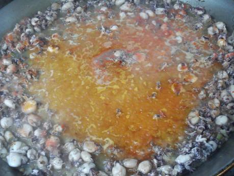 Arroz negro en paella (traditional black rice paella,  mediterranean style)