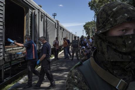 Members of a Dutch forensics team prepare to inspect rail cars where the bodies of the Malaysia Airlines Flight 17 crash victims were being held in Torez, Ukraine.