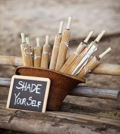 Set up an umbrella station at a beach wedding so guests can shade themselves from the sun (or ... rain!)