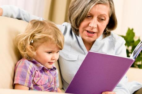 Grandmother and granddaughter read book together