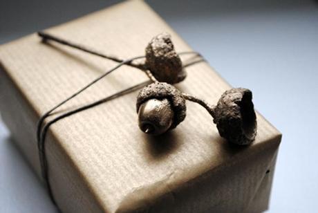 Envoltorio de regalo con papel kraft y bellotas pintadas de dorado