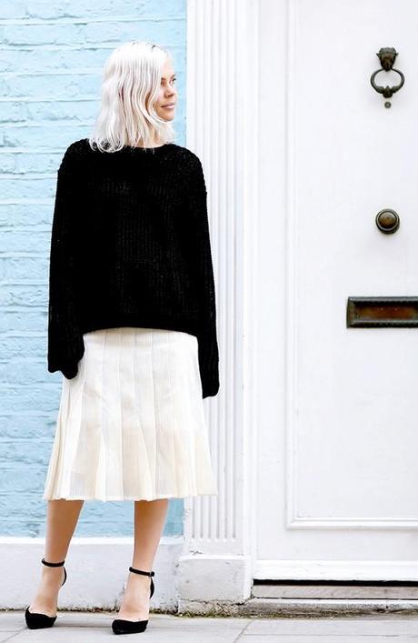 white pleated skirt and black sweater