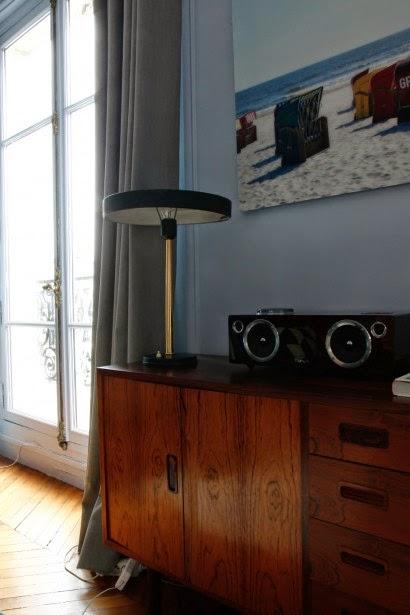 Un salón con un gran espejo sol convertido en reloj