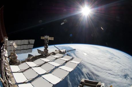 Endeavours final spacewalk - A bright sun, a portion of the International Space Station and Earth's horizon
