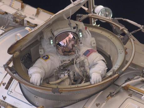 Astronaut Andrew Feustel reenters the space station after completing n 8-hour, 7-minute spacewalk