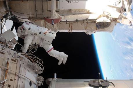 NASA astronaut Andrew Feustel is seen working while various components of the ISS are in view