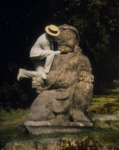 1895 hand-tinted lantern slide of a guardian statue at Borobudur