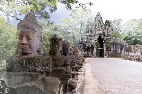 Mythic statues line the causeway over a moat leading to the south gate of Angkor Thom