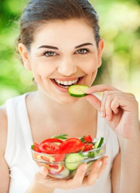 Beautiful young woman eating healthy salad