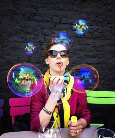 woman blowing soap bubbles