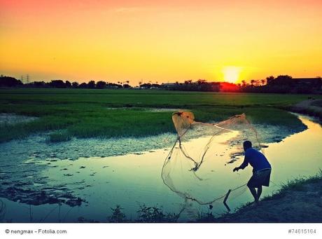 Local life in evening time (a man is catching fish)