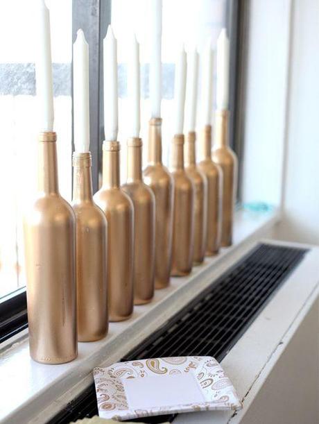 Use wine bottles to hold candles. /  21 Super Cute Ways To Decorate For Hanukkah (via BuzzFeed)