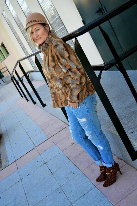 Fluffy coat, animal print and ripped jeans. Retro hat.