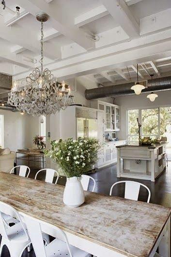 Rustic farmhouse style white and reclaimed wood, crystal chandelier, and airy space