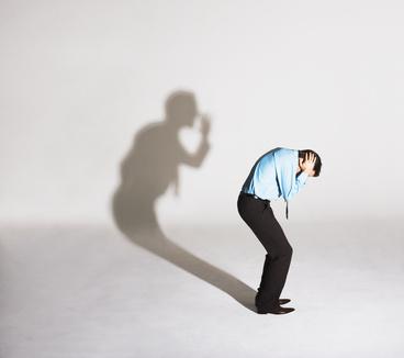 Man being scolded by his shadow