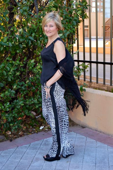 Fringed poncho and palazzo pants.