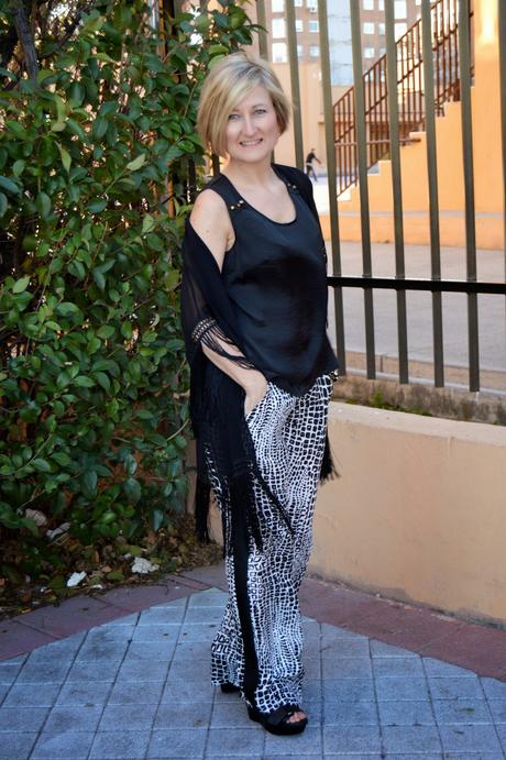 Fringed poncho and palazzo pants.