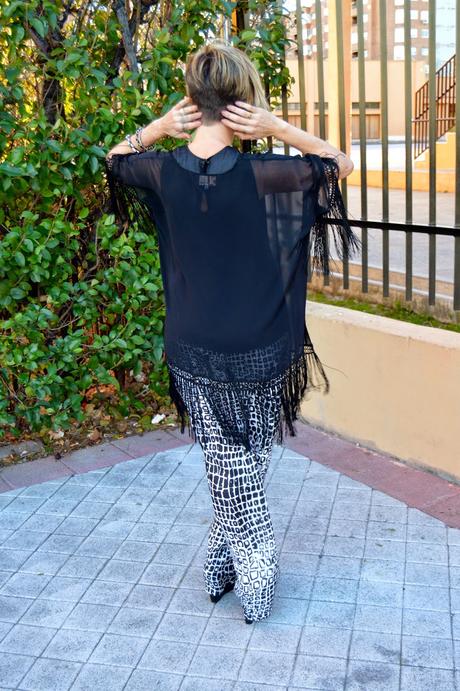 Fringed poncho and palazzo pants.