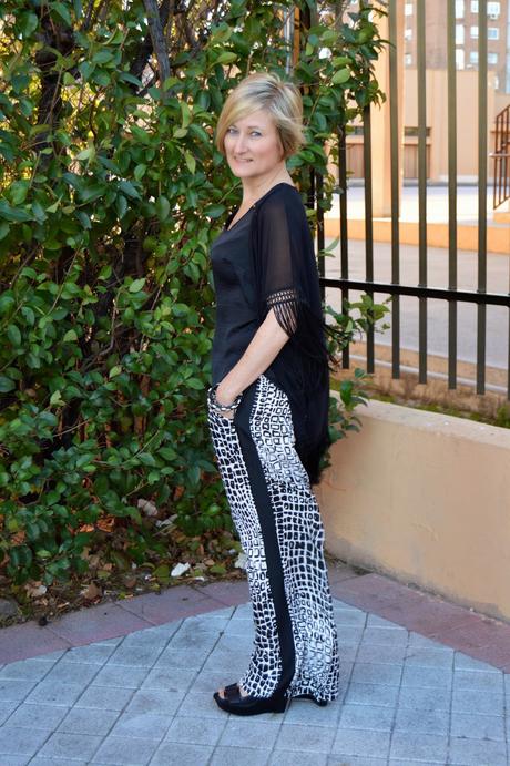 Fringed poncho and palazzo pants.