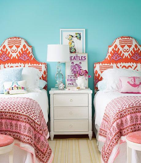 Headboards, upholstered in an ikat print by Quadrille, flank a Bungalow 5 nightstand in the girl's room of this Cape Cod home. Small throw pillows by Jonathan Adler and cotton sari blankets layer on extra personality. The walls are painted Caribbean Cool by Benjamin Moore. - CountryLiving.com