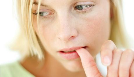 Young Woman Biting Her Finger Nail