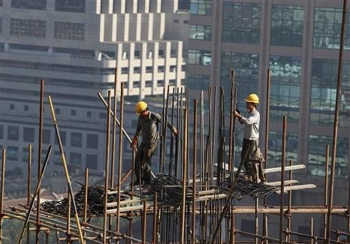 Foto del 21 de octubre del 2009 muestra la construcción de un rascacielos en la ciudad meridional china de Shanghai. La economía china creció un 8,9% en el tercer trimestre gracias a los gastos extraordinarios del gobierno. (Foto A/Eugene Hoshiko)
