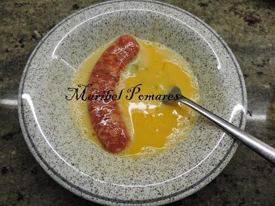 Salchichas empanadas con pan rallado con queso, ajo y perejil, con acompañamiento de cebolla, calabacin y pimientos a la planchas.