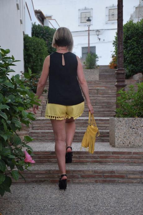 Mustard shorts and fringed bag