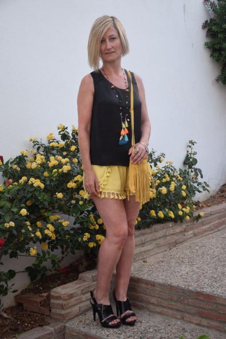 Mustard shorts and fringed bag