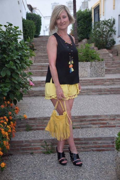 Mustard shorts and fringed bag