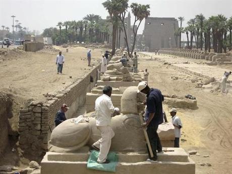 Restoration work is done on the Avenue of the Sphinxes with Karnak Temple (background) in Luxor, around 650 km (404 miles) south of Cairo, May 11, 2010, The remains of a fifth century AD church and a Nilometer have been uncovered this week during routine excavations carried out during an Egyptian mission at the Avenue of Sphinxes, Egypt's Supreme Council of Antiquities, Zahi Hawass said. REUTERS/Egyptian Supreme Council/Handout (EGYPT - Tags: SOCIETY) FOR EDITORIAL USE ONLY. NOT FOR SALE FOR MARKETING OR ADVERTISING CAMPAIGNS