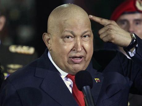 FILE - In this Oct. 11, 2011, file photo, Venezuela's President Hugo Chavez points at his head  to show that his hair has started to grow back after his last round of chemotherapy at Miraflores presidential palace in Caracas, Venezuela. Venezuela's Communication and Information Minister Ernesto Villegas on Monday, March 4, 2013, reported that President Hugo Chavez's health has deteriorated and remains delicate. Villegas also announced in the national TV broadcaster VTV that the president is undergoing chemotherapy with high impact. (AP Photo/Ariana Cubillos, file)