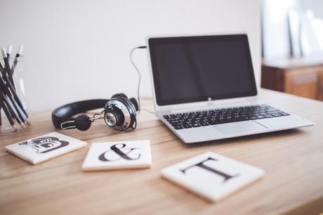 kaboompics.com_Headphones and Laptop on a wooden desk