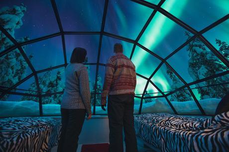 Kakslauttanen glass igloo inside Northern Lights