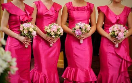 Row of bridesmaids with bouquets at wedding ceremony