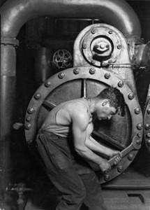 220px-Lewis_Hine_Power_house_mechanic_working_on_steam_pump