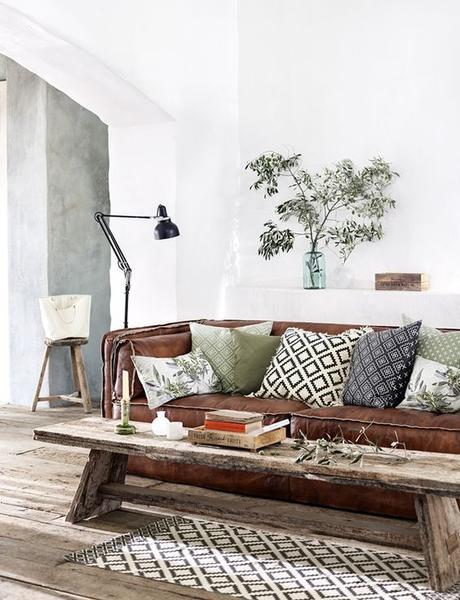 sofa marron con cojines verdes