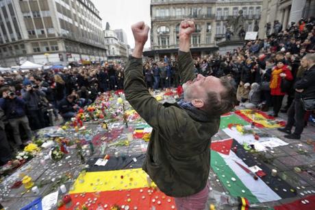 A man reacts at a street memorial following Tuesday's bomb attacks in Brussels, Belgium, March 23, 2016. REUTERS/Francois Lenoir TPX IMAGES OF THE DAY