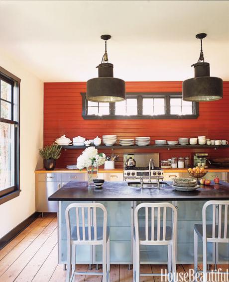 In this Long Island kitchen in a former camp cottage, designer Amanda Kyser chose Benjamin Moore's Merlot Red for one wall. It sets off white dishware salvaged from a grand seaside hotel in France that was torn down. 
